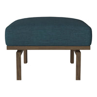 Teal upholstered ottoman with a textured fabric and wooden legs, perfect for modern decor. 