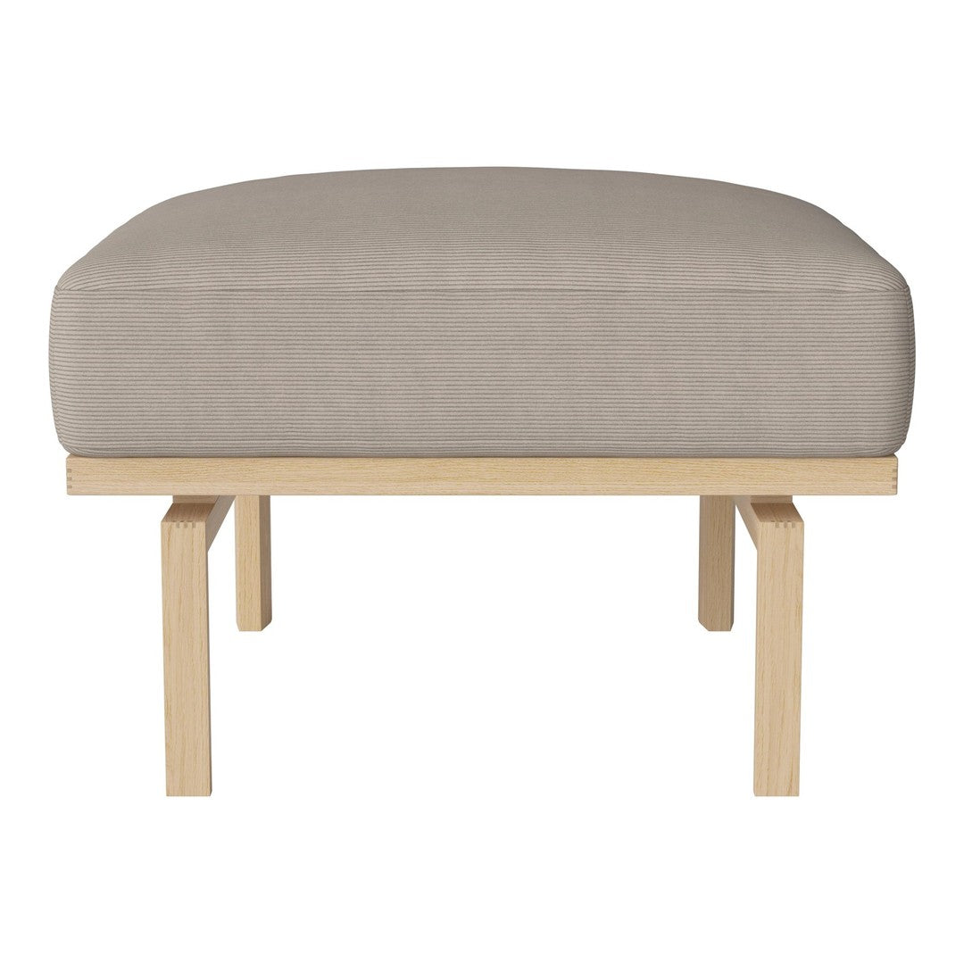 Light beige ottoman with a smooth fabric cushion and simple wooden frame, ideal for modern decor.