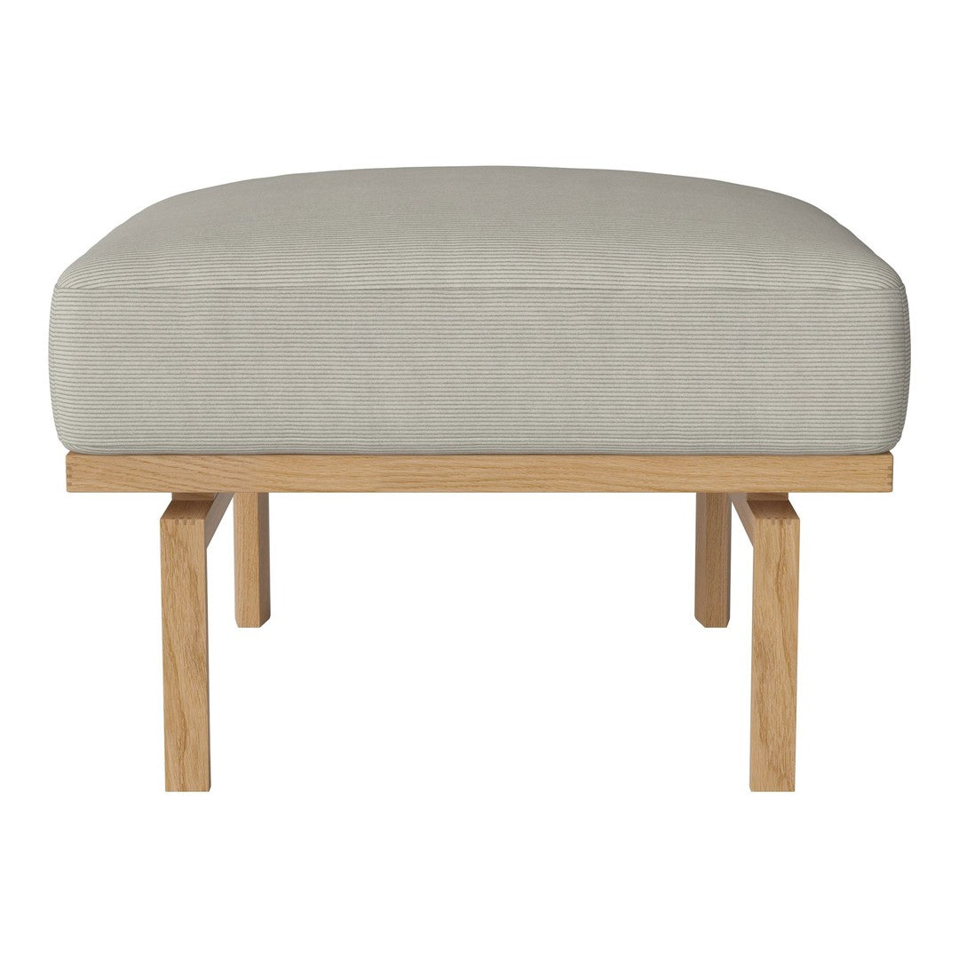 Light gray upholstered ottoman with a smooth fabric and natural wooden legs. Simple, modern design for versatile use.