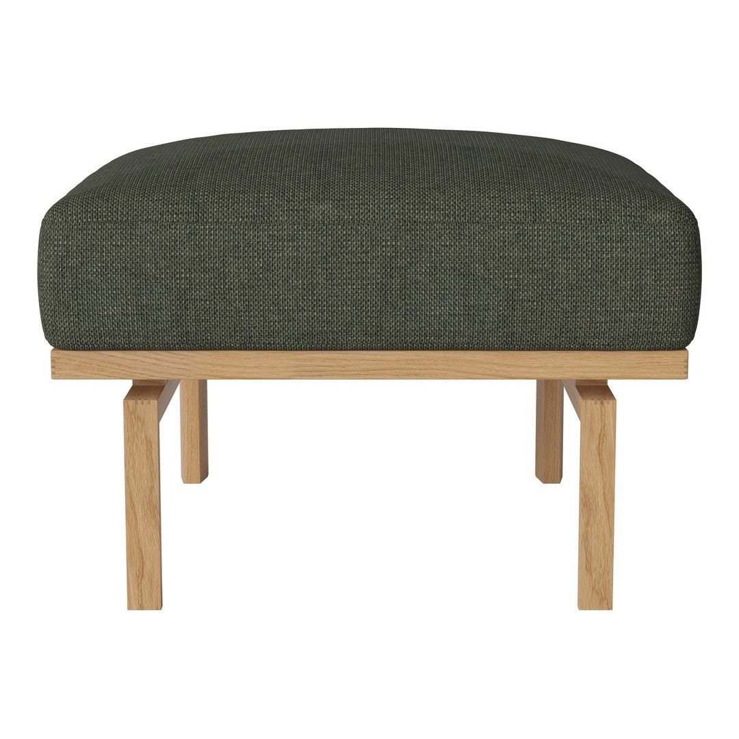 Green upholstered ottoman with a textured fabric and natural wood legs, perfect for modern decor.