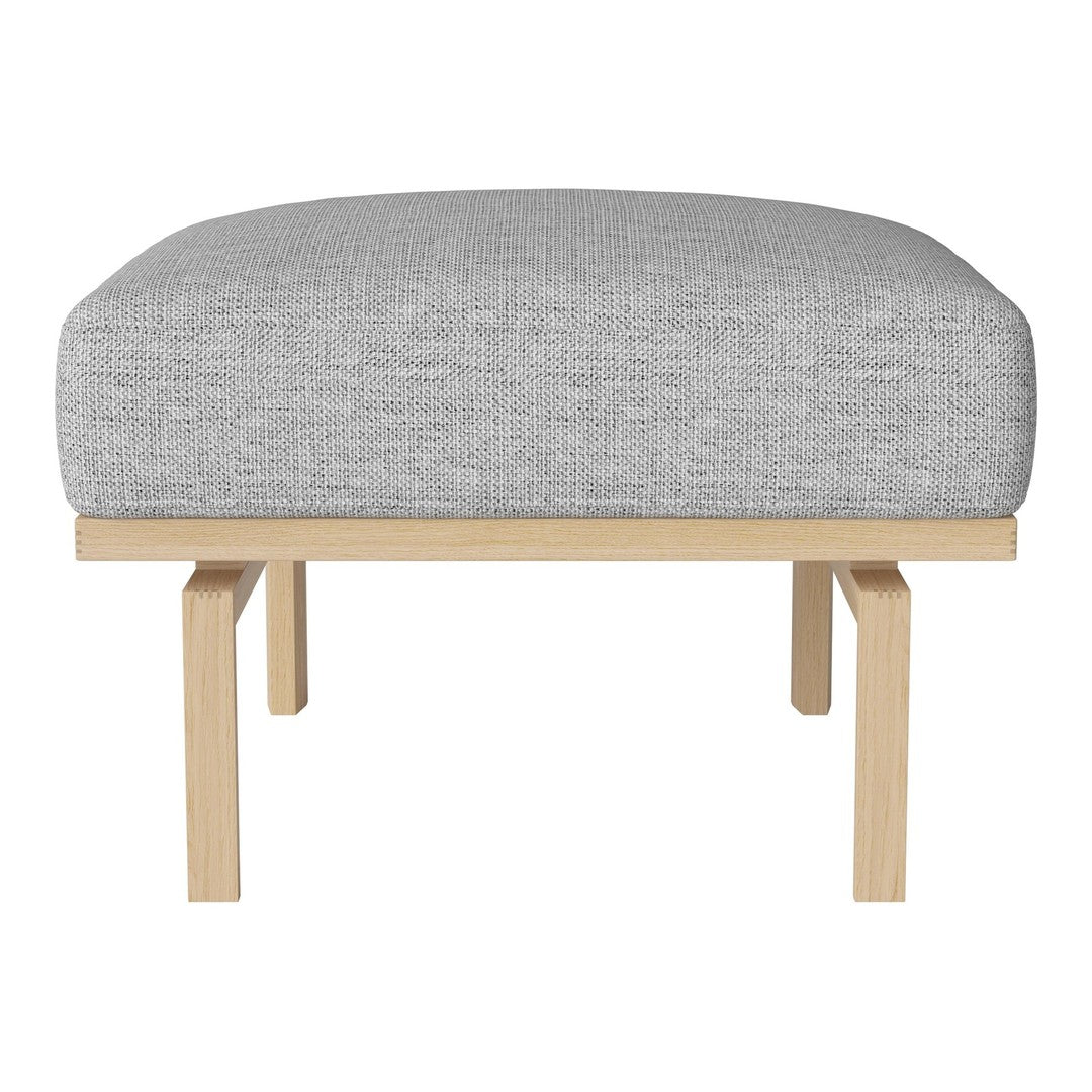 Gray upholstered ottoman with a minimalist wooden frame, featuring a smooth, textured fabric. Ideal for modern decor.
