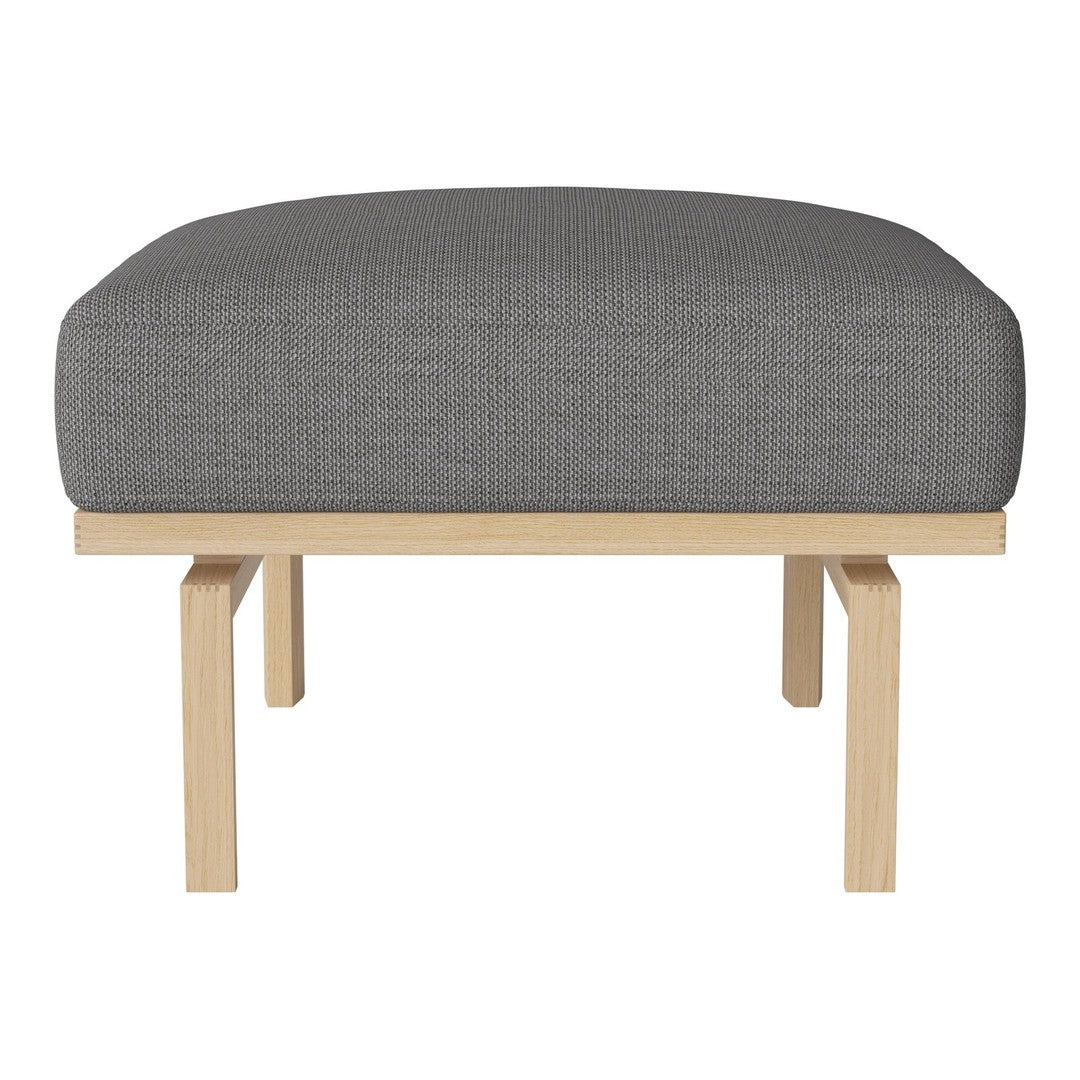 Gray upholstered ottoman with a clean, minimalist design and light wooden legs. Ideal for modern interiors.