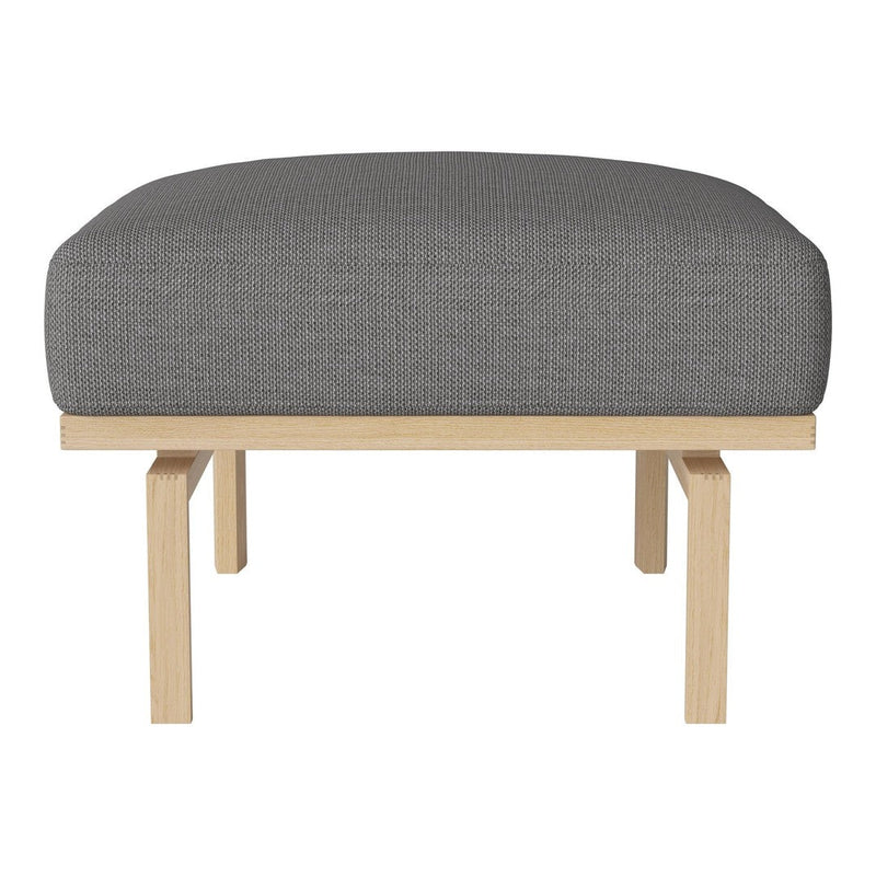 Gray upholstered ottoman with a clean, minimalist design and light wooden legs. Ideal for modern interiors.