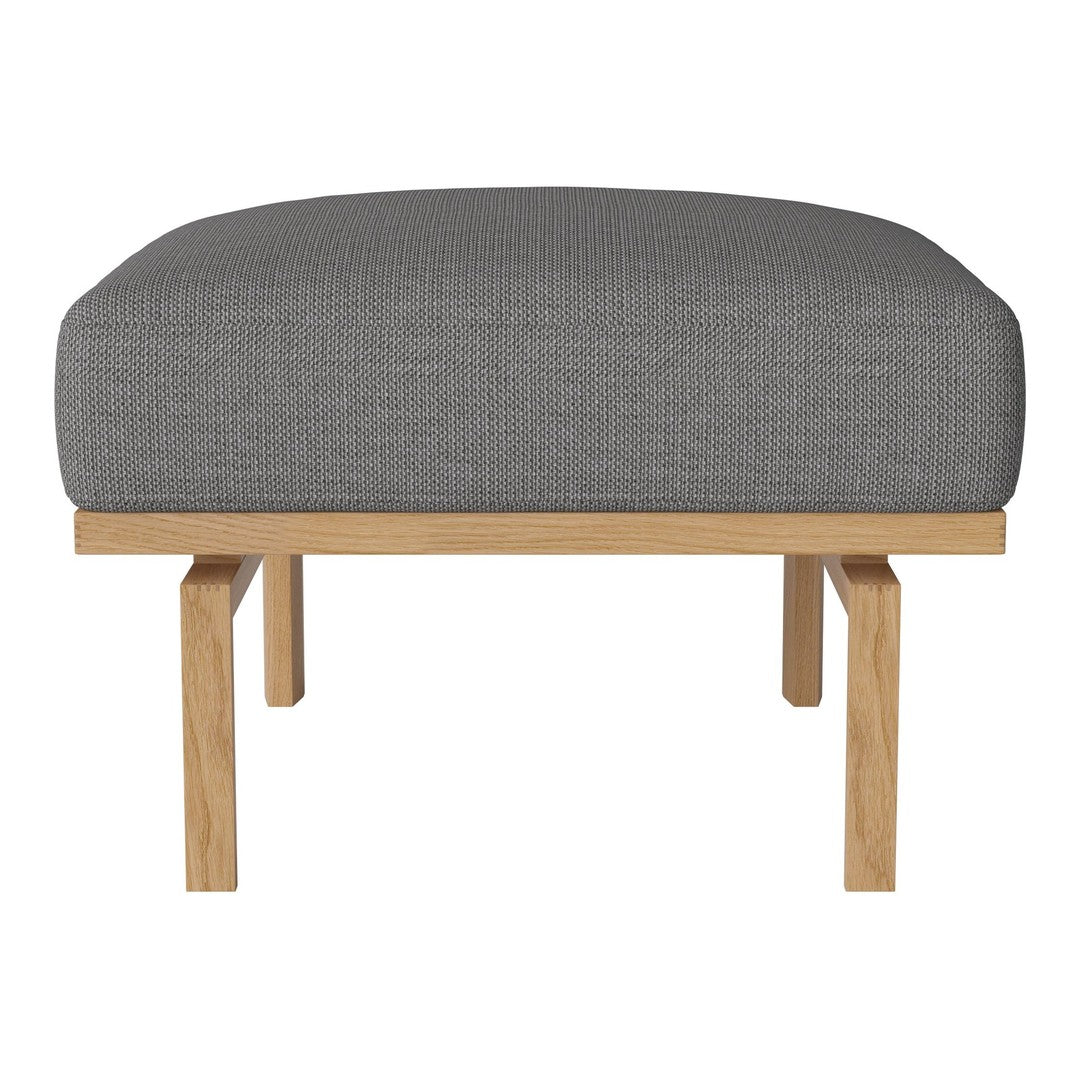 Gray upholstered ottoman with a smooth texture and light wood legs, featuring a minimalist design. Ideal for modern decor.