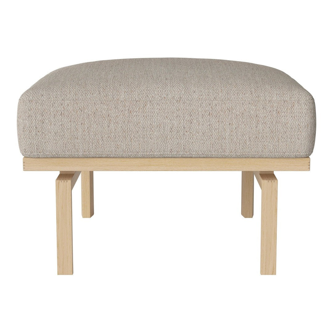 Beige upholstered ottoman with subtle textured fabric and natural wood legs. Ideal for modern living spaces.