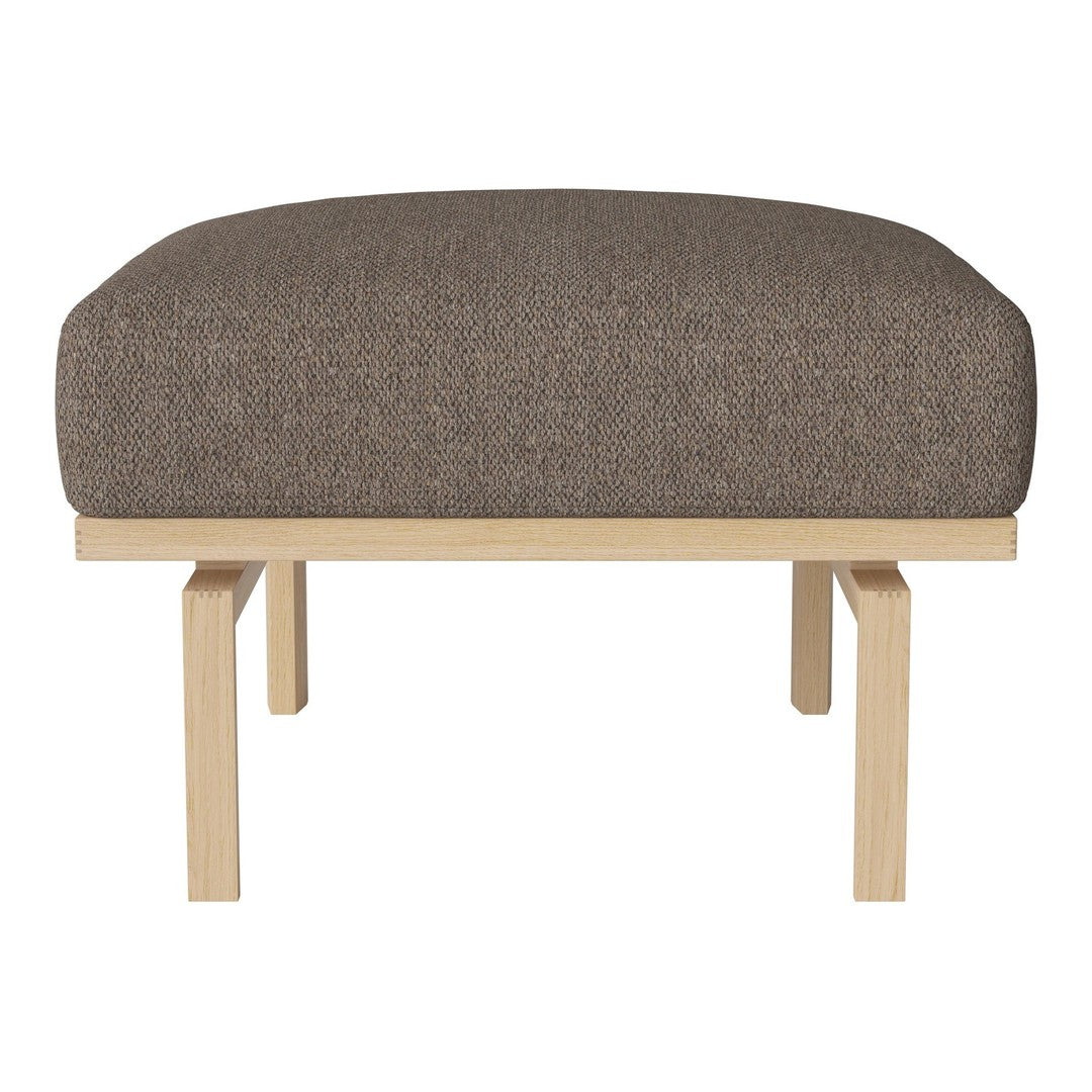 Brown upholstered ottoman with a smooth, rounded cushion and light wooden base. Perfect for modern decor.
