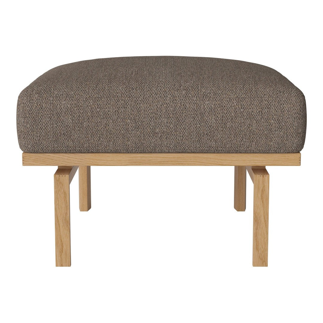 Brown upholstered ottoman with a smooth texture and natural wooden legs. Minimalist design for modern decor.