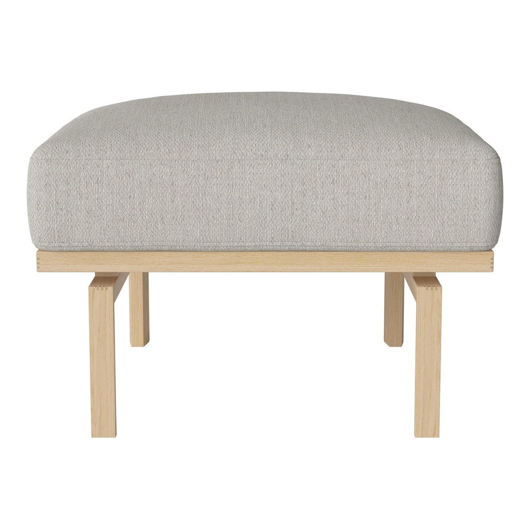 Light gray upholstered ottoman with a simple design, featuring a natural wood base for a modern touch.