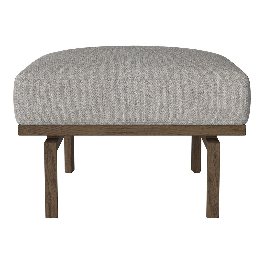 Light gray upholstered ottoman with a textured pattern and dark wood legs. Perfect for modern decor.