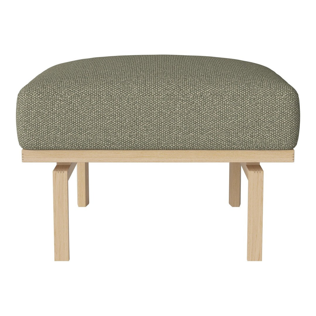 "Olive green upholstered ottoman with a textured pattern and natural wood legs."