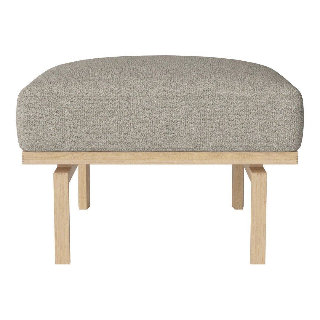 Light gray upholstered ottoman with a simple wood frame, featuring a smooth, minimalist design. Perfect for any decor.