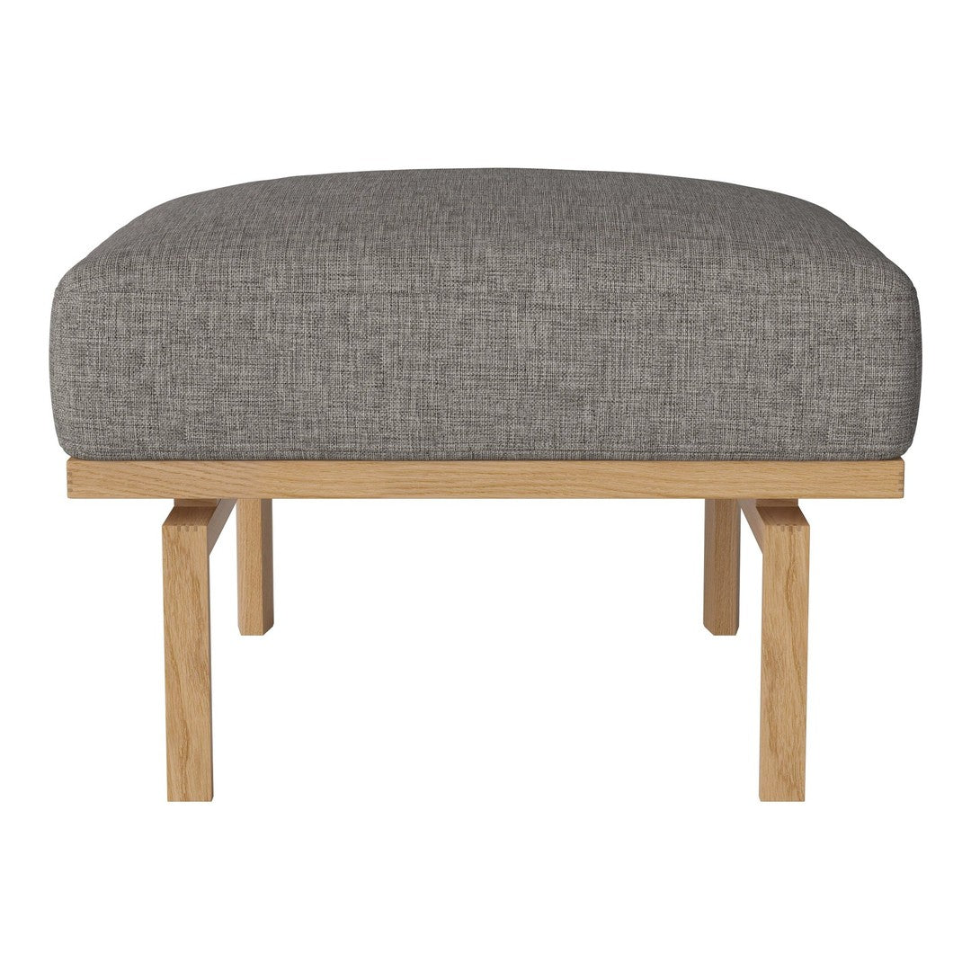 Gray upholstered ottoman with a smooth texture and natural wood legs, perfect for modern decor.