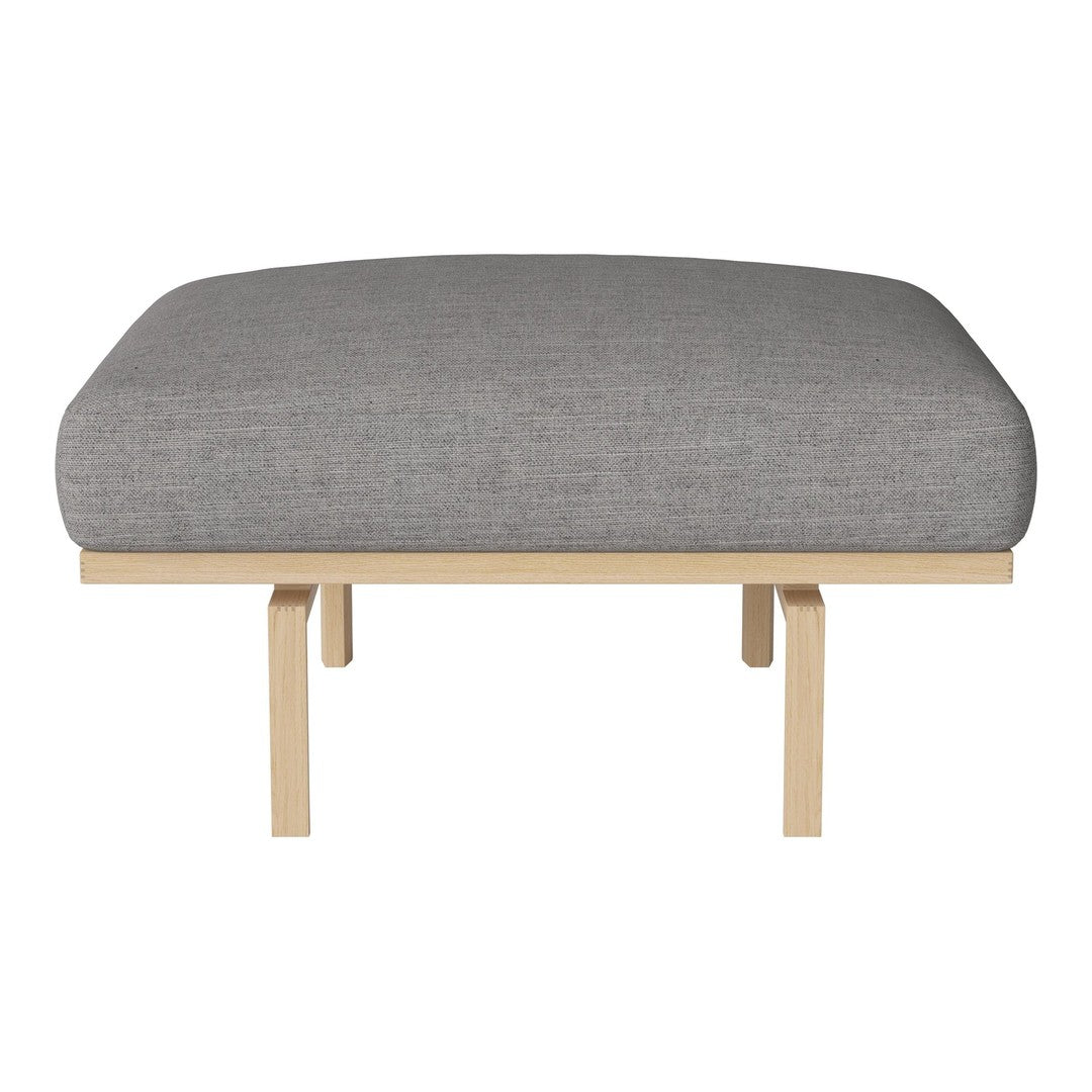 Gray upholstered cushion atop a sleek, light wood frame. Minimalist design with a modern, neutral color palette.