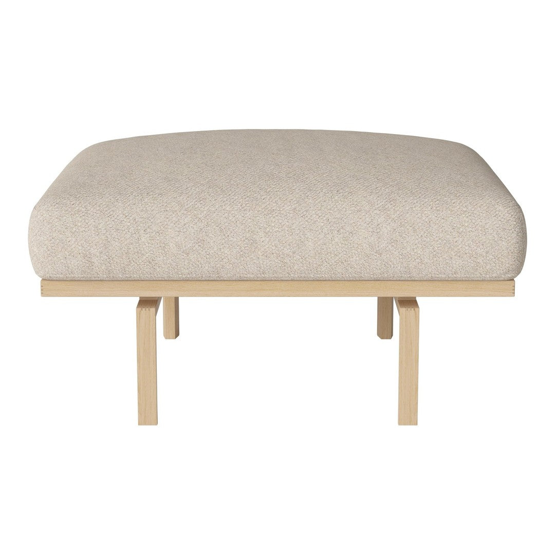 Beige upholstered ottoman with a smooth, simple texture and light wooden legs. Perfect for modern decor.