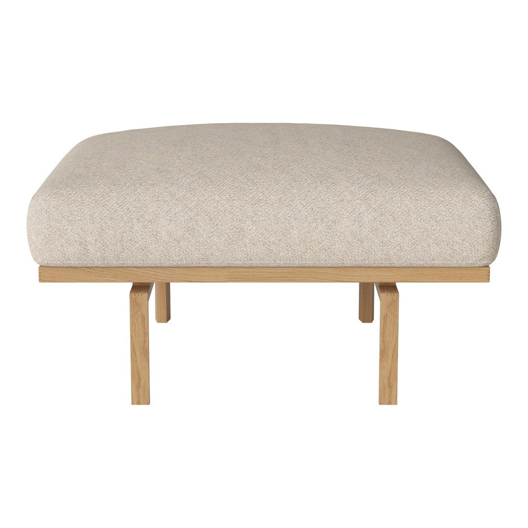 Beige upholstered ottoman with a smooth surface and light wood legs, ideal for modern decor.