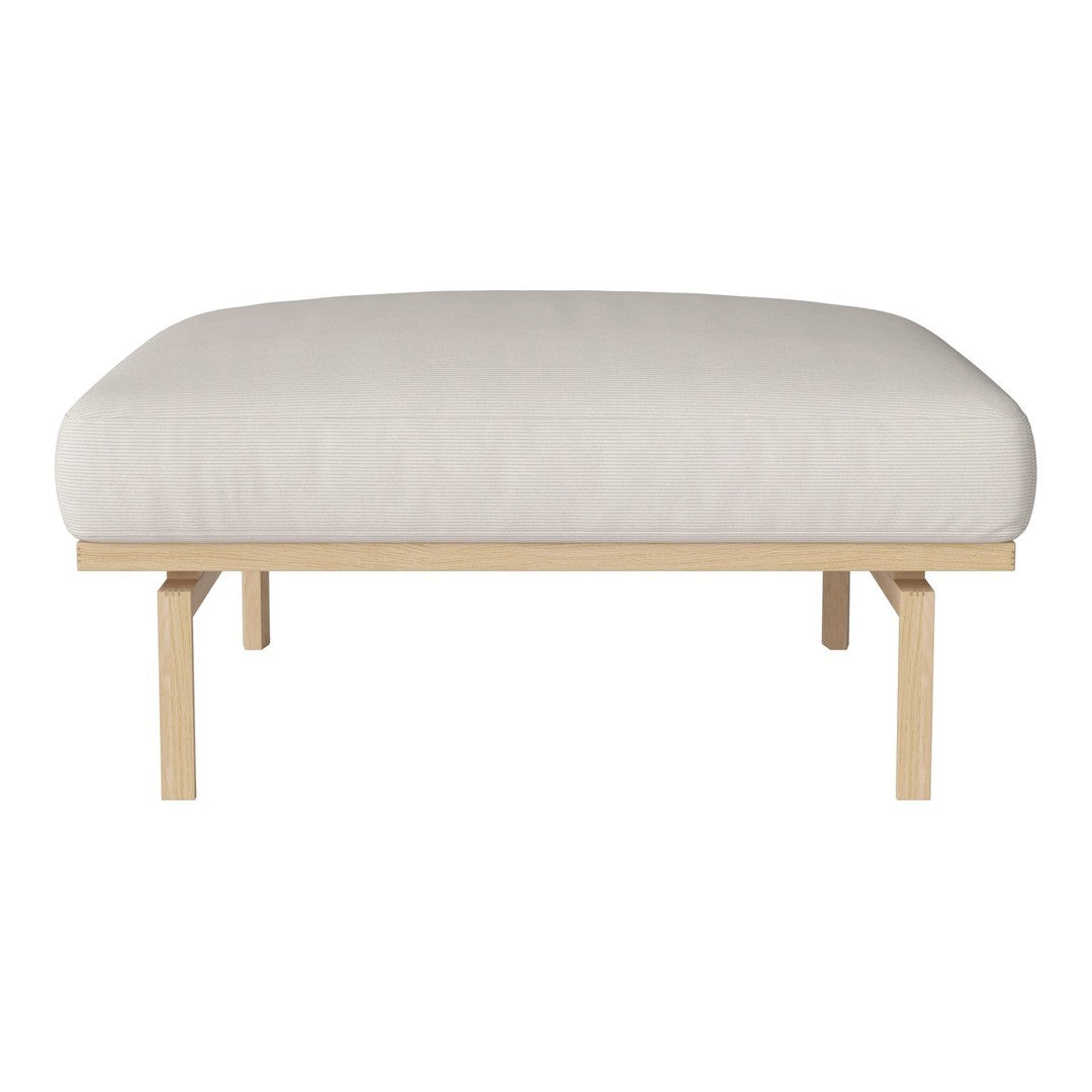 Cream cushioned ottoman with a smooth surface and light wood legs, featuring a minimalist design.