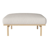 Cream cushioned ottoman with a smooth surface and light wood legs, featuring a minimalist design.