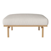Cream-colored padded seat with a minimalist design and light wooden legs. Smooth texture, modern style.