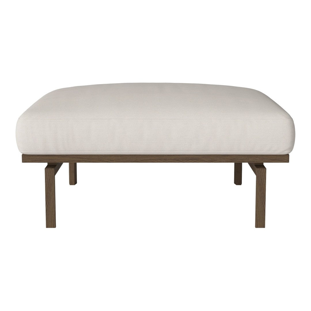 Beige upholstered ottoman with smooth, minimalist design and sturdy brown metal frame.
