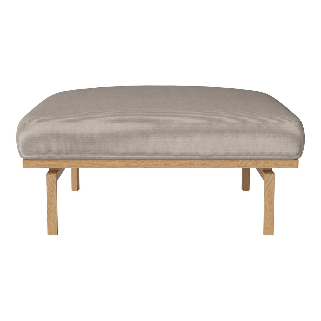 Beige cushioned ottoman with a smooth fabric surface, supported by natural wood legs. Modern and minimalist design.
