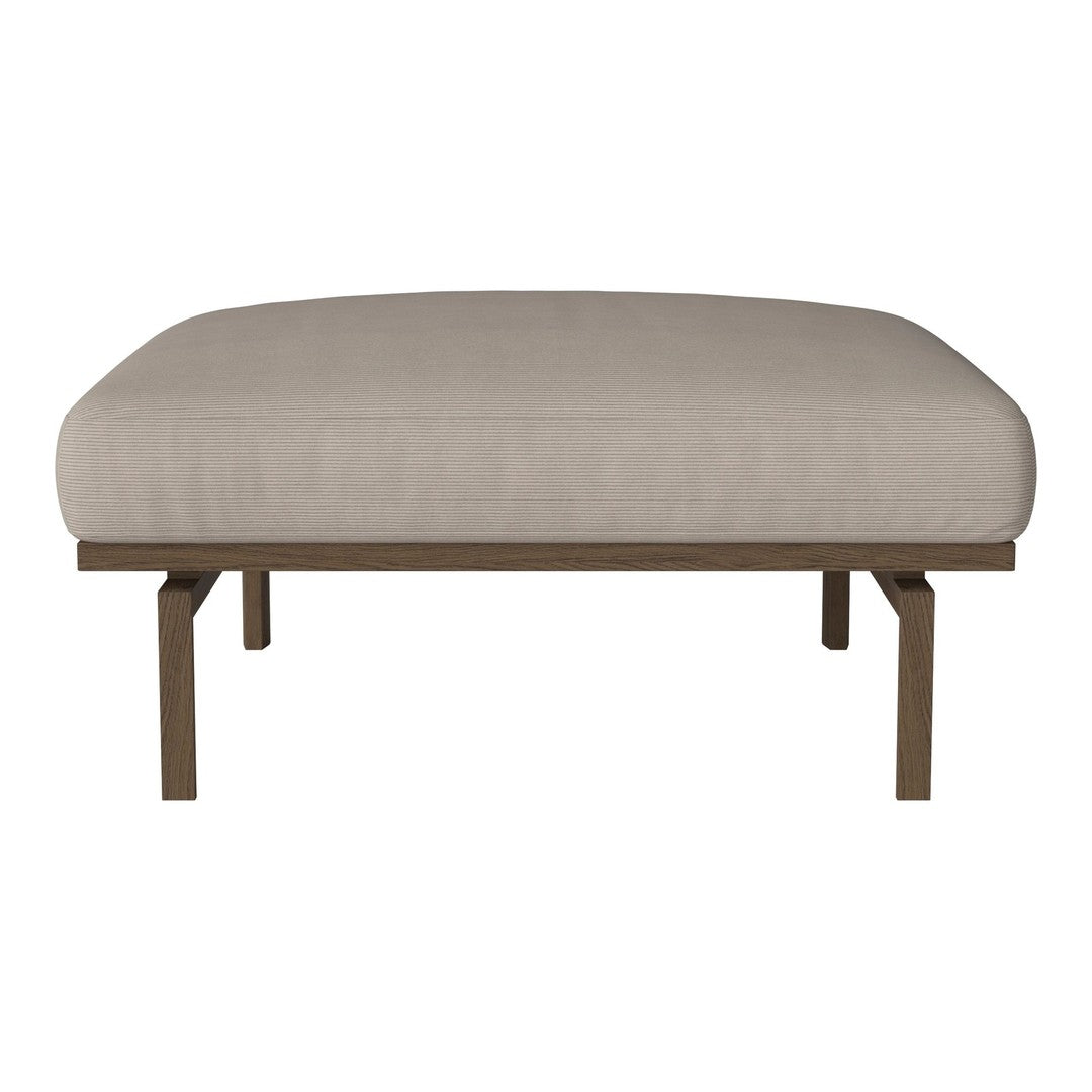 Beige upholstered ottoman with a smooth fabric surface and sleek wooden legs. Minimalistic design with modern appeal.