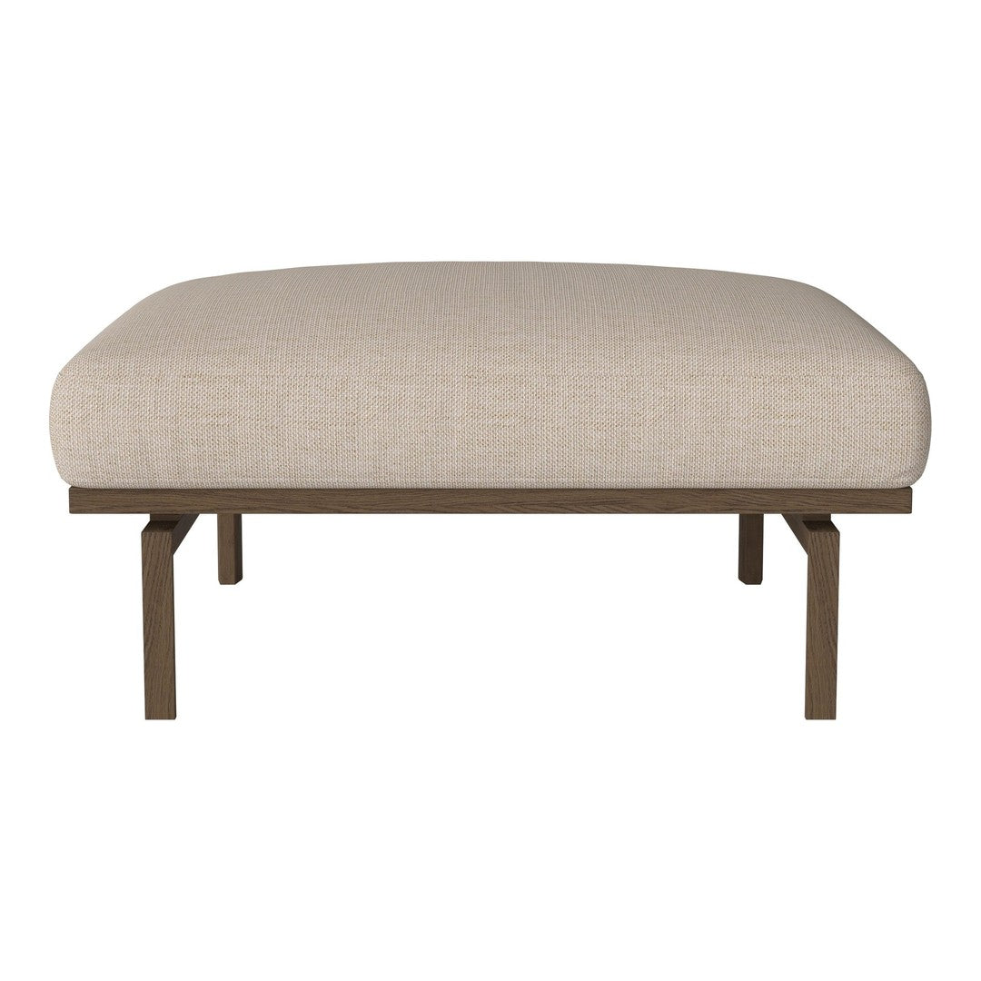 Light beige upholstered ottoman with a smooth, minimalist design and sturdy metal legs. Perfect for any modern decor.