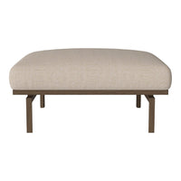 Light beige upholstered ottoman with a smooth, minimalist design and sturdy metal legs. Perfect for any modern decor.