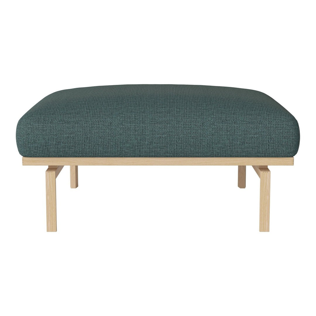 Teal upholstered ottoman with a textured pattern and light wood legs, perfect for modern decor.