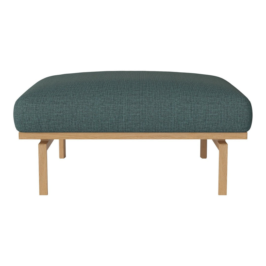 Teal upholstered ottoman with a textured fabric, featuring natural wood legs for a modern, minimalist look.