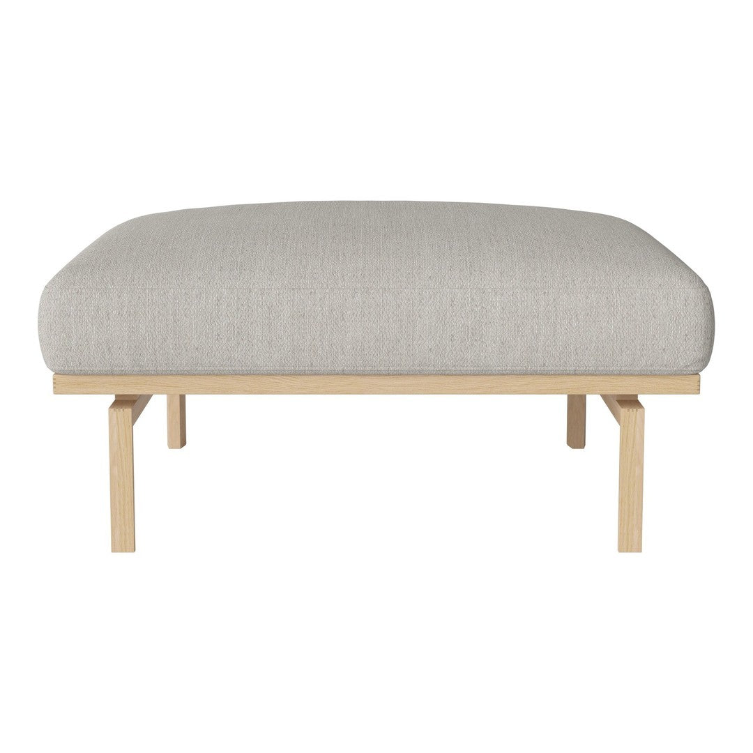 Light gray upholstered cushion with a smooth texture, set on a natural wood frame. Minimalist and modern design.
