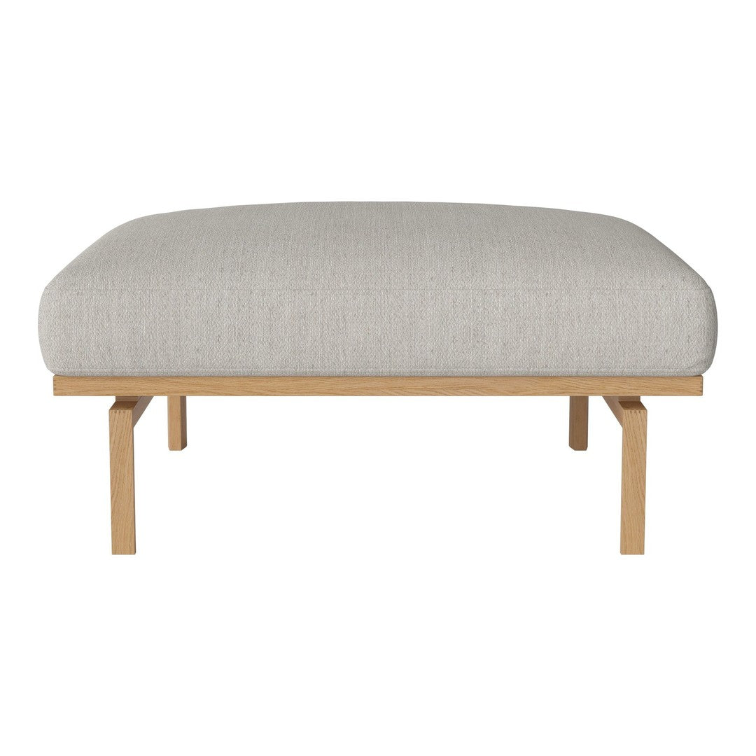 Light gray upholstered ottoman with a smooth texture, set on natural wood legs for a modern, minimalist look.
