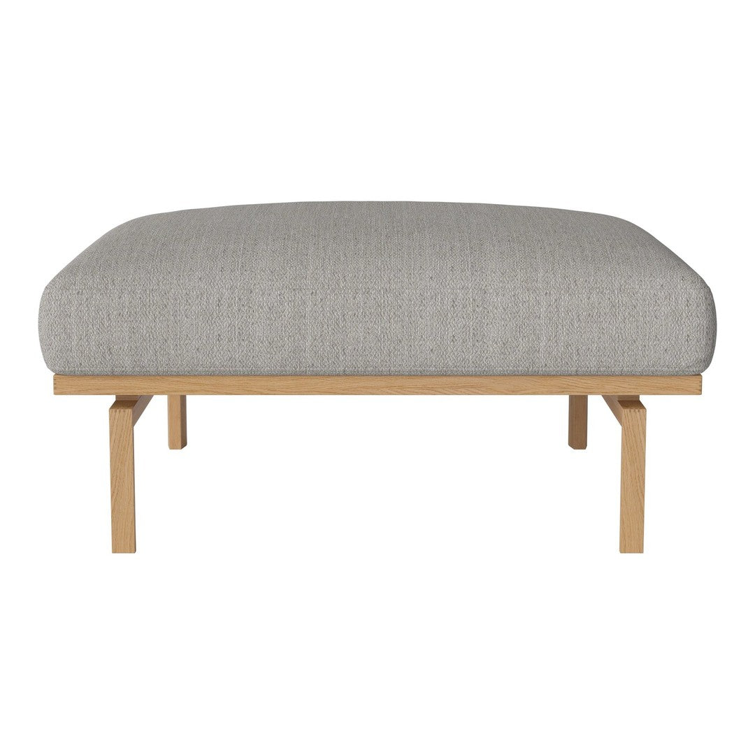 Light gray upholstered ottoman with subtle textured pattern, supported by natural wood legs. Perfect for modern decor.
