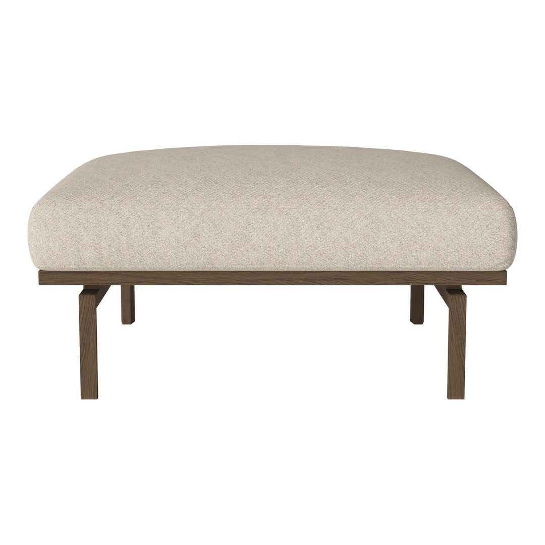 Beige upholstered ottoman with a rounded top and metal frame, perfect for modern or minimalist decor.