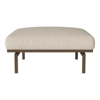 Beige upholstered ottoman with a rounded top and metal frame, perfect for modern or minimalist decor.