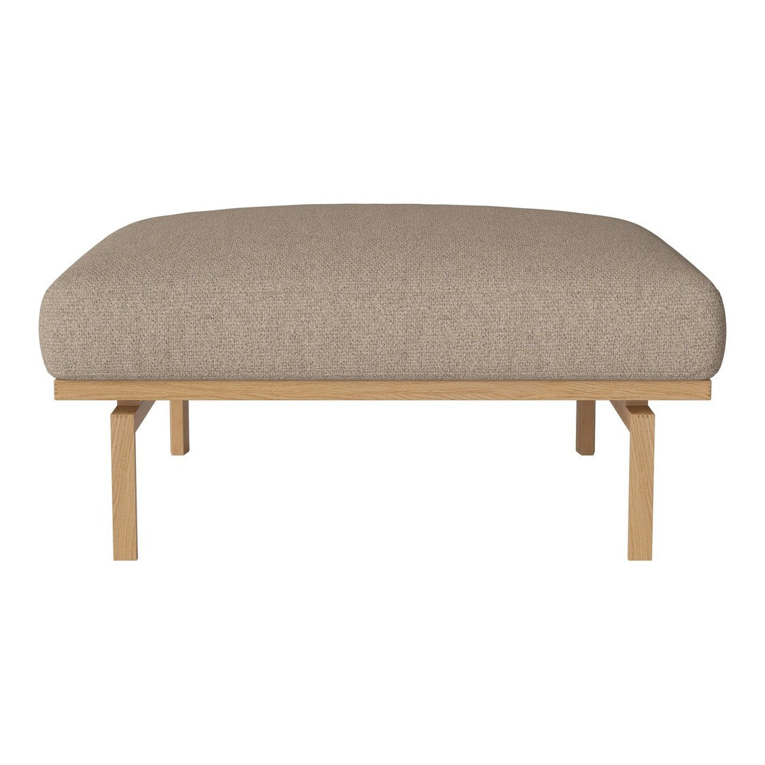 Neutral beige upholstered cushion with a smooth texture on a light wooden frame. Simple, modern design.