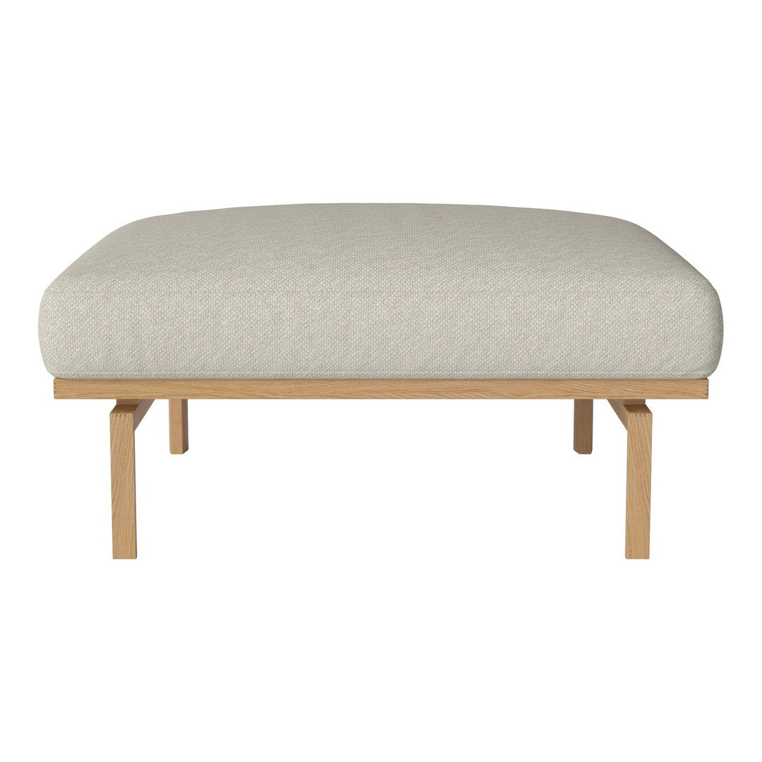 Light beige upholstered ottoman with a smooth, textured surface and natural wood legs for a modern touch.