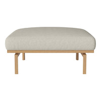 Light beige upholstered ottoman with a smooth, textured surface and natural wood legs for a modern touch.