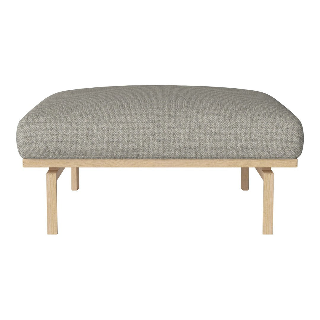 Gray upholstered ottoman with a smooth, rounded top, supported by minimalist wooden legs.