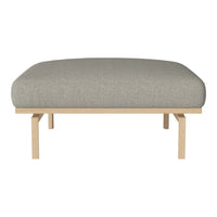 Gray upholstered ottoman with a smooth, rounded top, supported by minimalist wooden legs.