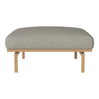 Light gray upholstered cushion on a natural wood frame with clean lines and minimalistic design.