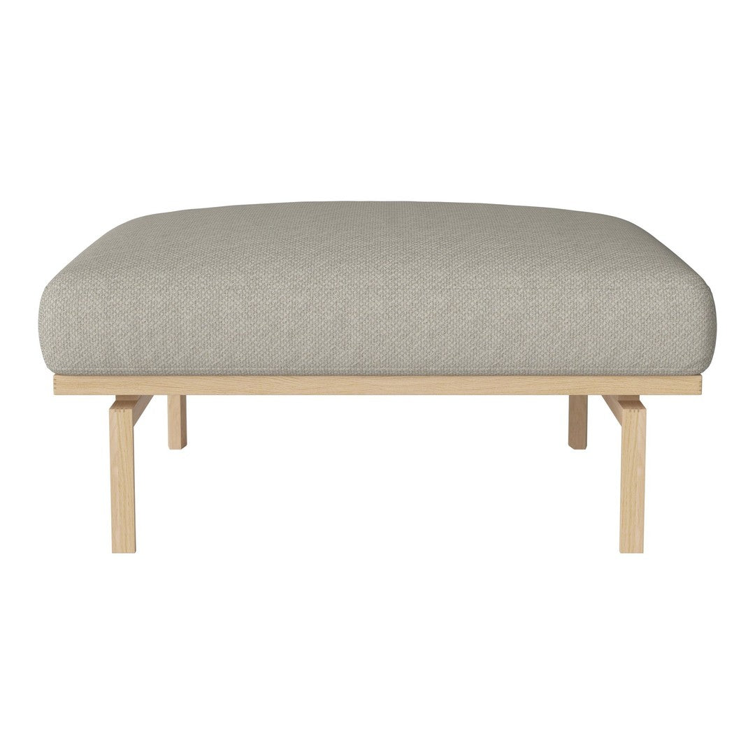 Light gray cushioned ottoman with smooth, minimalistic design and natural wood legs. Perfect for any modern space.