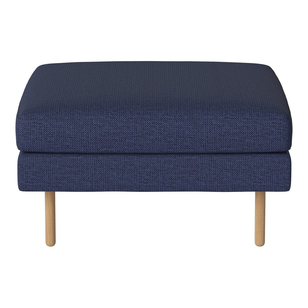 Dark navy blue upholstered ottoman with a textured pattern and light wood legs. Perfect for modern decor.