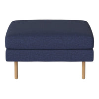 Dark navy blue upholstered ottoman with a textured pattern and light wood legs. Perfect for modern decor.