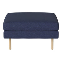Navy blue upholstered ottoman with a textured pattern and light wood legs. Ideal for modern decor.