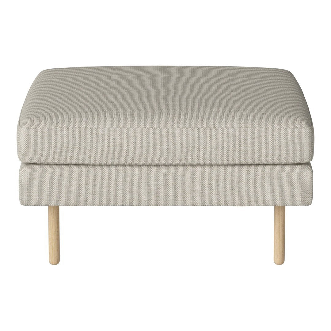 Light beige ottoman with a smooth, textured fabric and wooden legs, perfect for modern decor.
