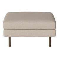 Beige upholstered ottoman with a smooth texture and minimalist design, featuring slender dark metal legs.