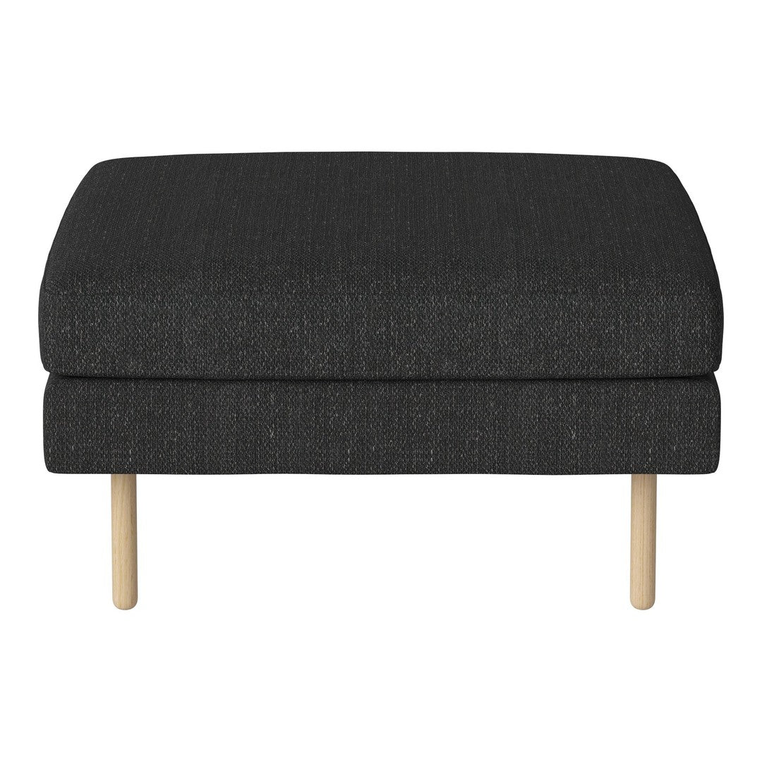 Black upholstered ottoman with a smooth texture and light wooden legs. Minimalist design with a contemporary feel.