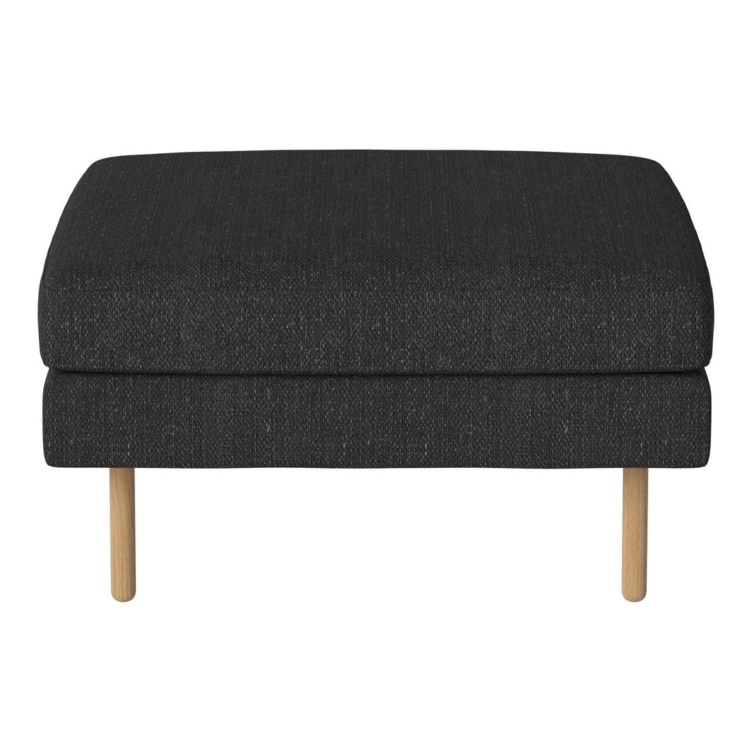 Dark gray upholstered ottoman with a subtle textured pattern and light wooden legs. Modern and stylish decor accent.