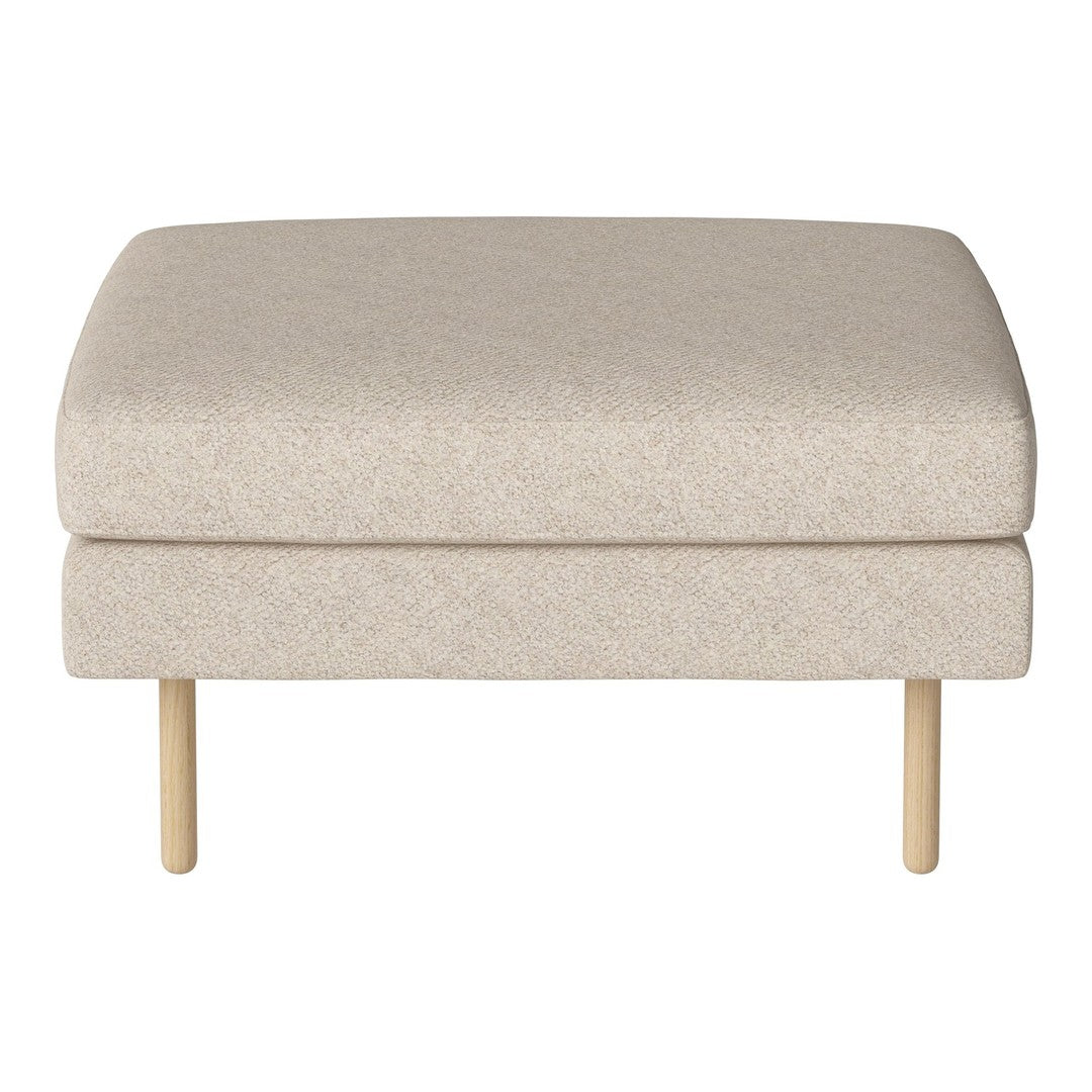 Beige upholstered ottoman with a subtle textured pattern, featuring light wood legs. Minimalist design for any decor.
