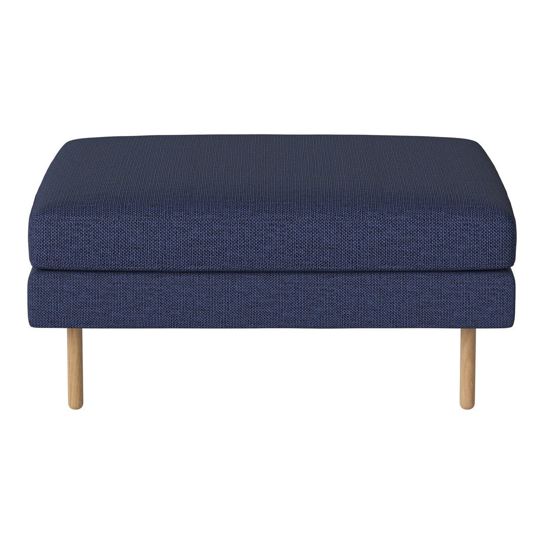 Navy blue upholstered ottoman with a solid pattern and natural wood legs, ideal for modern living spaces.